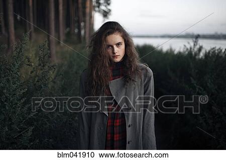 Caucasian woman standing in woods near lake View Large Photo Image Stock Image - Caucasian woman standing in woods near lake. Fotosearch