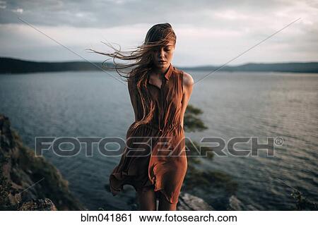 Caucasian woman standing near remote lake View Large Photo Image Stock Image - Caucasian woman standing near remote lake. Fotosearch