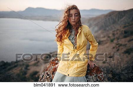 Caucasian woman standing on coastal hillside View Large Photo Image Stock Image - Caucasian woman standing on coastal hillside. Fotosearch