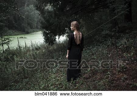 Caucasian woman standing on forest hillside View Large Photo Image Stock Photograph - Caucasian woman standing on forest hillside. Fotosearch