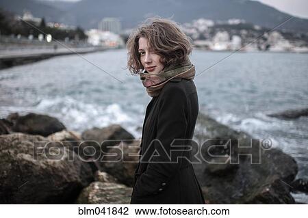 Caucasian woman standing on rock formation in harbor View Large Photo Image Stock Image - Caucasian woman standing on rock formation in harbor. Fotosearch