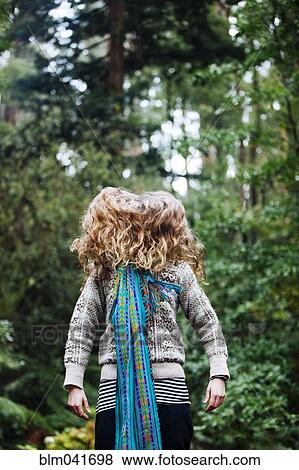 Caucasian woman tossing hair in forest View Large Photo Image Stock Photo - Caucasian woman tossing hair in forest. Fotosearch