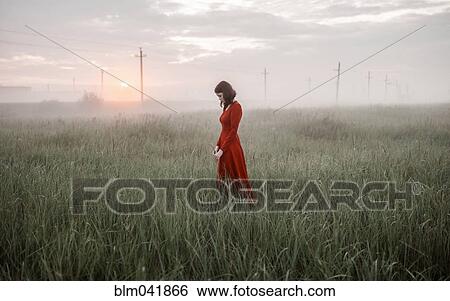Caucasian woman walking in remote field View Large Photo Image Stock Photograph - Caucasian woman walking in remote field. Fotosearch