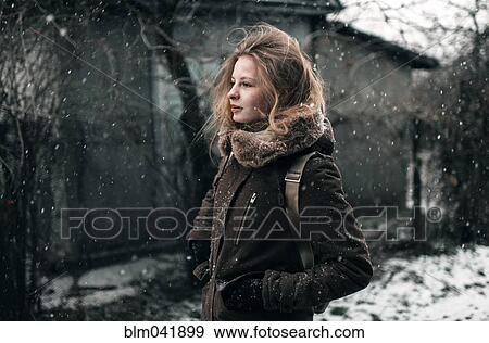 Stock Photo - Caucasian woman walking in snow. Fotosearch