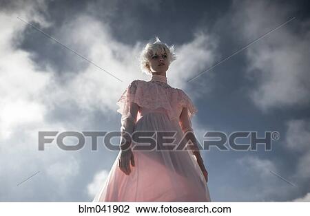 Caucasian woman walking under cloudy sky View Large Photo Image Stock Image - Caucasian woman walking under cloudy sky. Fotosearch