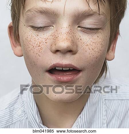 Stock Photography - Close up of Caucasian boy with freckles. Fotosearch