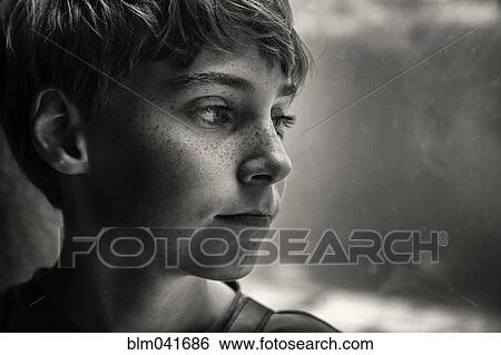 Stock Photograph - Close up of face of serious Caucasian boy. Fotosearch