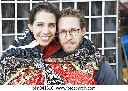 Couple wrapped in blanket outdoors View Large Photo Image Stock Photograph - Couple wrapped in blanket outdoors. Fotosearch