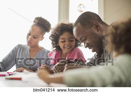 Family drawing together in kitchen View Large Photo Image Picture - Family drawing together in kitchen. Fotosearch