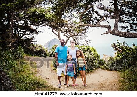 Family smiling on beach path View Large Photo Image Stock Photograph - Family smiling on beach path. Fotosearch