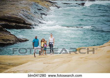 Family smiling on beach View Large Photo Image Stock Image - Family smiling on beach. Fotosearch