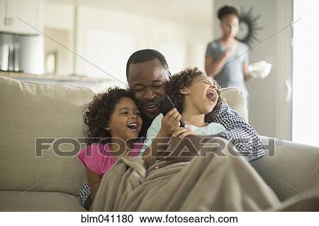 Father and daughters playing on sofa View Large Photo Image Stock Image - Father and daughters playing on sofa. Fotosearch