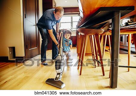 Father and son vacuuming kitchen View Large Photo Image Stock Photography - Father and son vacuuming kitchen. Fotosearch