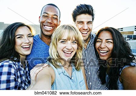 Stock Image - Friends posing for selfie outdoors. Fotosearch