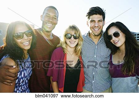 Stock Photo - Friends smiling outdoors. Fotosearch