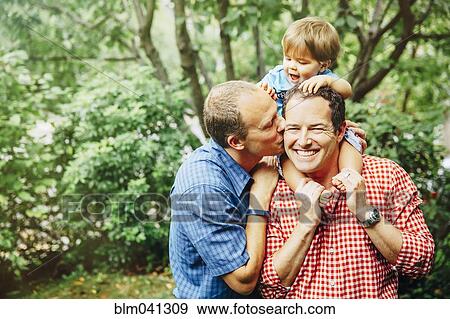 Gay fathers holding baby son outdoors View Large Photo Image Stock Photo - Gay fathers holding baby son outdoors. Fotosearch