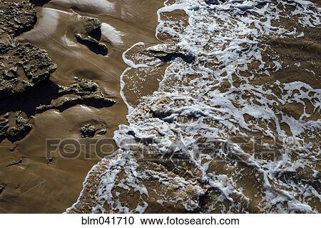 Stock Image - High angle view of waves on beach. Fotosearch