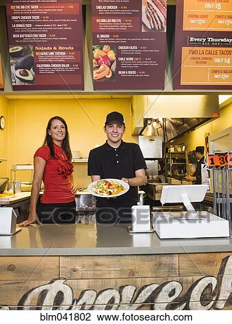Hispanic server and businesswoman smiling in cafe View Large Photo Image Stock Image - Hispanic server and businesswoman smiling in cafe. Fotosearch