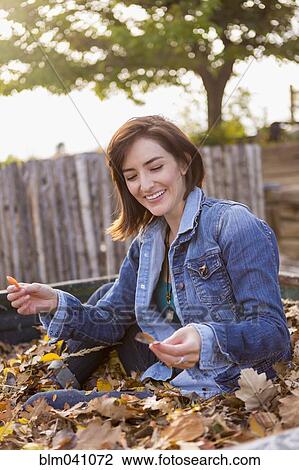 Stock Image - Hispanic woman playing in truck bed. Fotosearch