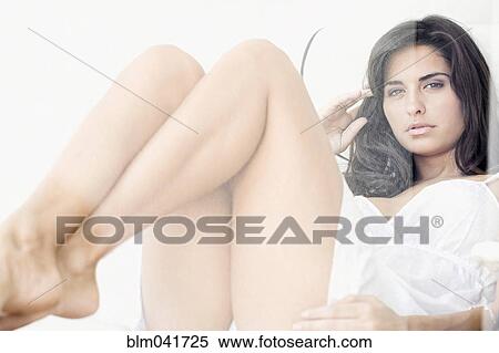 Stock Photography - Hispanic woman sitting in chair. Fotosearch