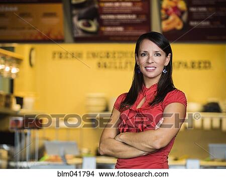 Picture - Hispanic woman smiling in cafe. Fotosearch