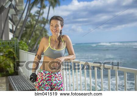 Stock Photo - Mixed race amputee athlete smiling outdoors. Fotosearch
