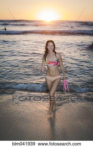 Mixed race amputee carrying fins on beach View Large Photo Image Stock Photo - Mixed race amputee carrying fins on beach. Fotosearch