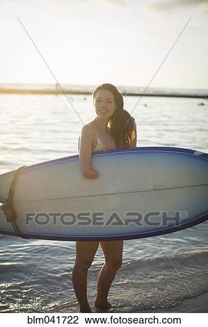 Mixed race amputee carrying surfboard on beach View Large Photo Image Stock Image - Mixed race amputee carrying surfboard on beach. Fotosearch