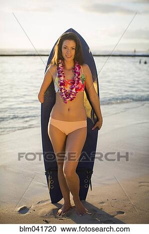 Mixed race amputee holding surfboard on beach View Large Photo Image Stock Image - Mixed race amputee holding surfboard on beach. Fotosearch