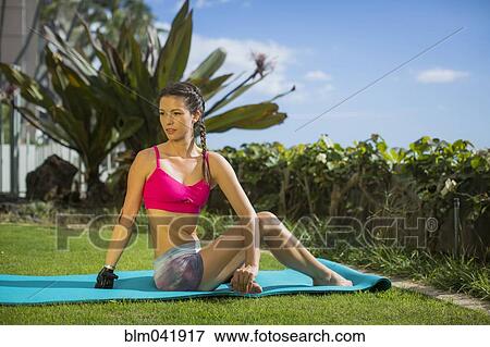 Stock Photo - Mixed race amputee stretching in grass. Fotosearch