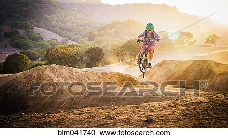Mixed race boy riding dirt bike on track View Large Photo Image Stock Image - Mixed race boy riding dirt bike on track. Fotosearch