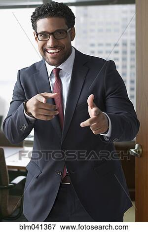 Stock Photo - Mixed race businessman smiling in office. Fotosearch