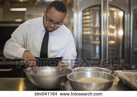 Mixed race chef with down syndrome cooking in restaurant View Large Photo Image Picture - Mixed race chef with down syndrome cooking in restaurant. Fotosearch