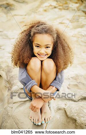 Mixed race girl hugging her knees View Large Photo Image Stock Photography - Mixed race girl hugging her knees. Fotosearch