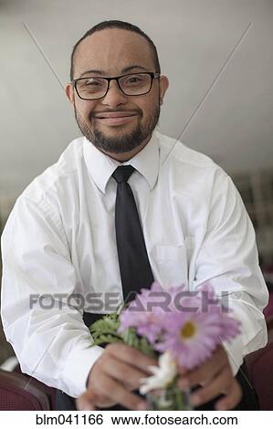Mixed race man arranging flowers View Large Photo Image Stock Photograph - Mixed race man arranging flowers. Fotosearch