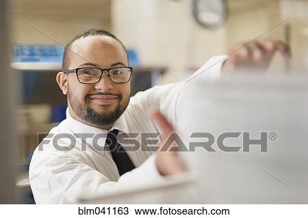 Mixed race server with down syndrome working in restaurant View Large Photo Image Stock Image - Mixed race server with down syndrome working in restaurant. Fotosearch