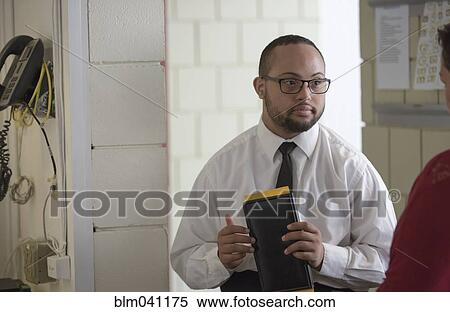 Stock Photography - Mixed race server working in restaurant. Fotosearch