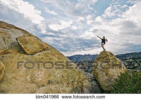 Mixed race woman climbing rock formation View Large Photo Image Stock Photograph - Mixed race woman climbing rock formation. Fotosearch