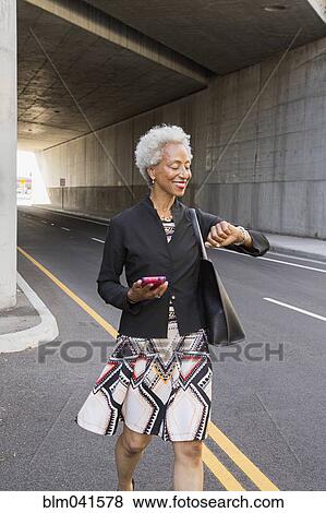 Older African American woman checking watch View Large Photo Image Stock Photo - Older African American woman checking watch. Fotosearch