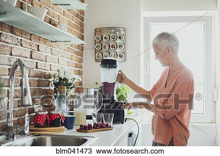 Older Caucasian woman blending smoothie in kitchen View Large Photo Image Stock Image - Older Caucasian woman blending smoothie in kitchen. Fotosearch