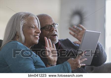 Older couple video chatting with digital tablet View Large Photo Image Stock Image - Older couple video chatting with digital tablet. Fotosearch