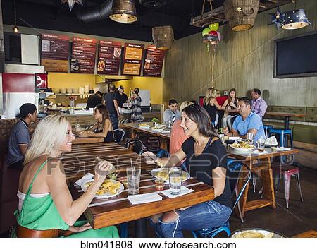 Stock Photo - People eating in cafe. Fotosearch