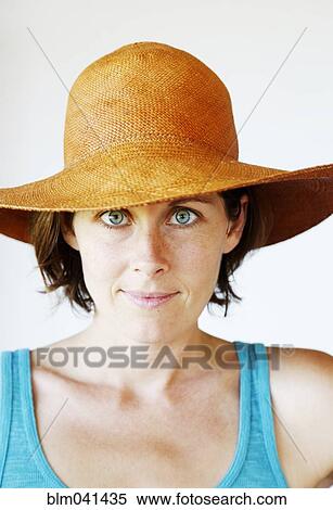 Stock Photography - Serious woman wearing sun hat. Fotosearch