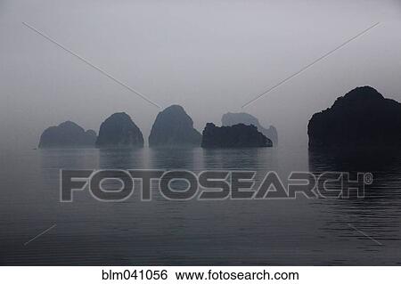 Stock Photograph - Silhouette of rock formations in Ha Long Bay, Quang Ninh Province, Vietnam. Fotosearch