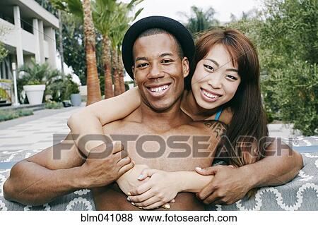 Smiling couple hugging outdoors View Large Photo Image Stock Photo - Smiling couple hugging outdoors. Fotosearch