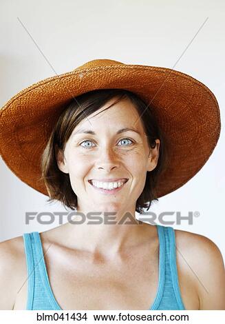 Smiling woman wearing sun hat View Large Photo Image Picture - Smiling woman wearing sun hat. Fotosearch