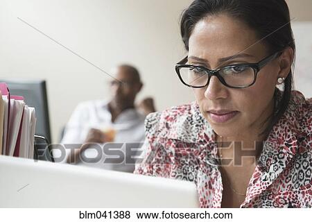 Stock Photo - Stressed businesswoman working in office. Fotosearch