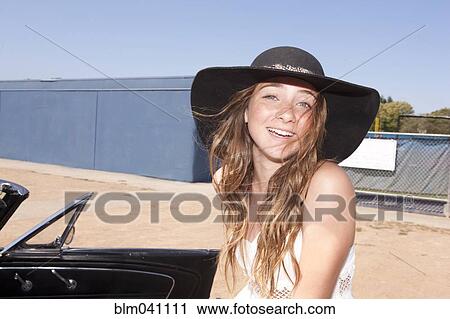 Stock Image - Teenage girl smiling outdoors. Fotosearch