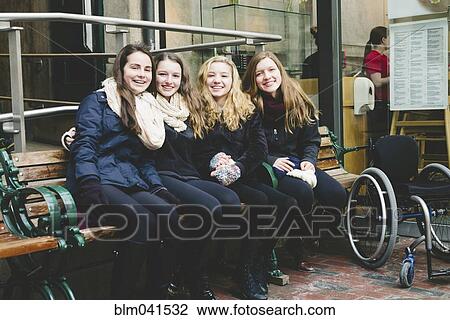 Teenage girls smiling on bench View Large Photo Image Stock Image - Teenage girls smiling on bench. Fotosearch