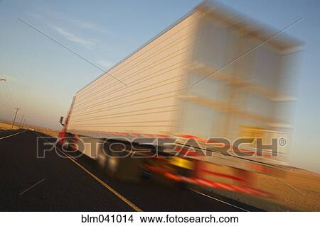 Picture - Truck driving on remote road. Fotosearch